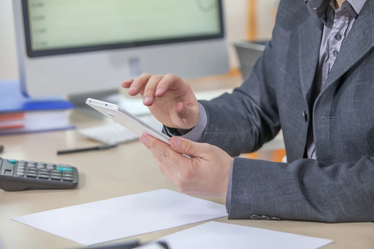 Young businessman working from his office on his tablet