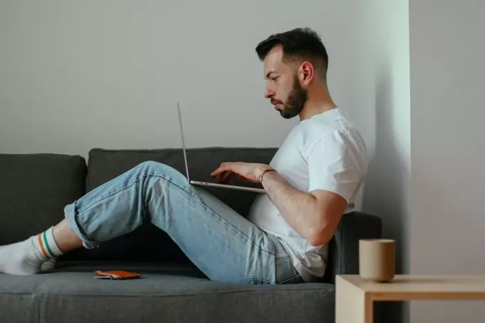 Férfi kutatja laptopon, hogy mennyi hitelt kaphat